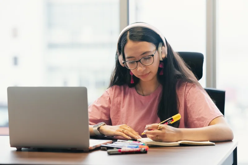 Adult learner practising listening with headphones